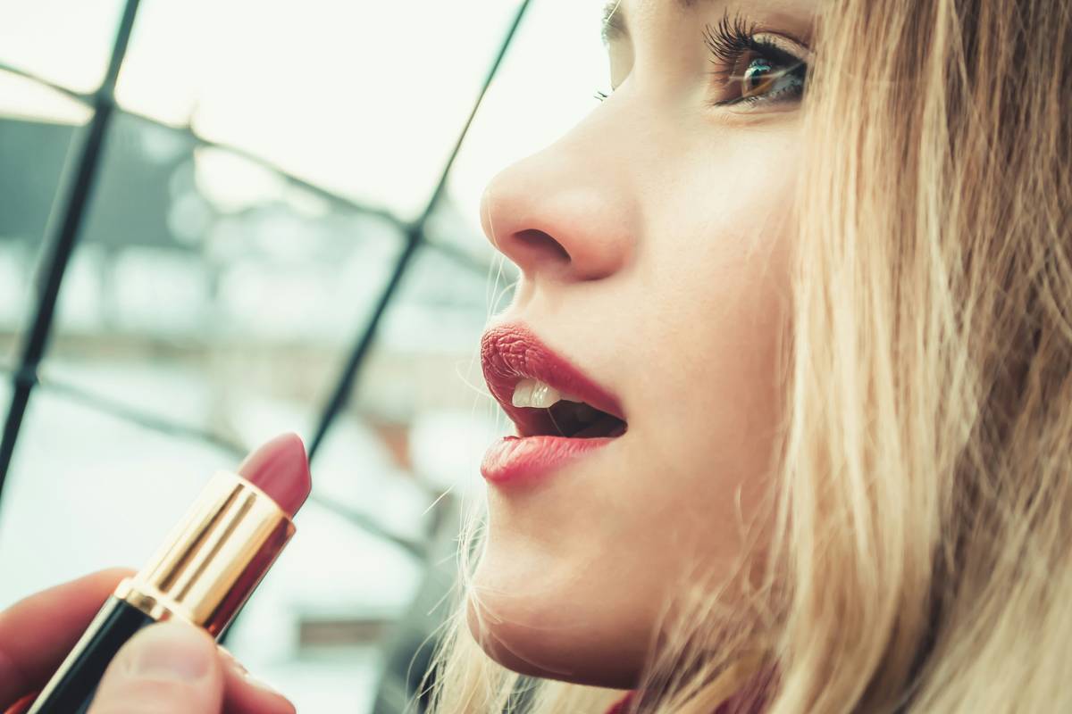 Infographic showing cool, warm, and neutral lip shades mapped to skin undertones with real lip crayon swatches