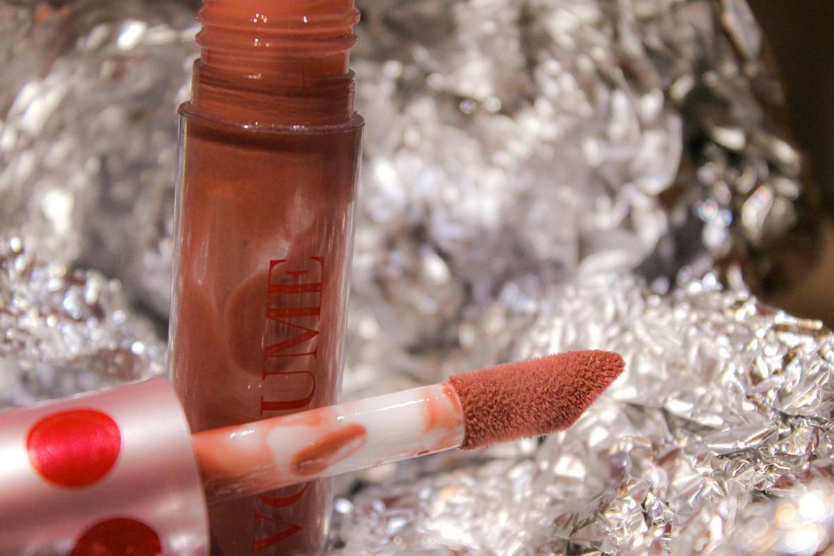 Close-up of finger blending lip crayon blend for soft ombré effect
